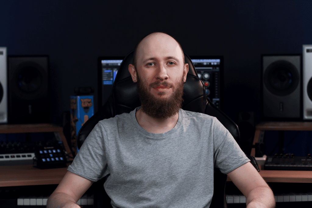 Oleg Yershov sitting on a chair in front of his computer